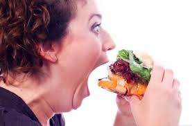 greedy woman eating burger